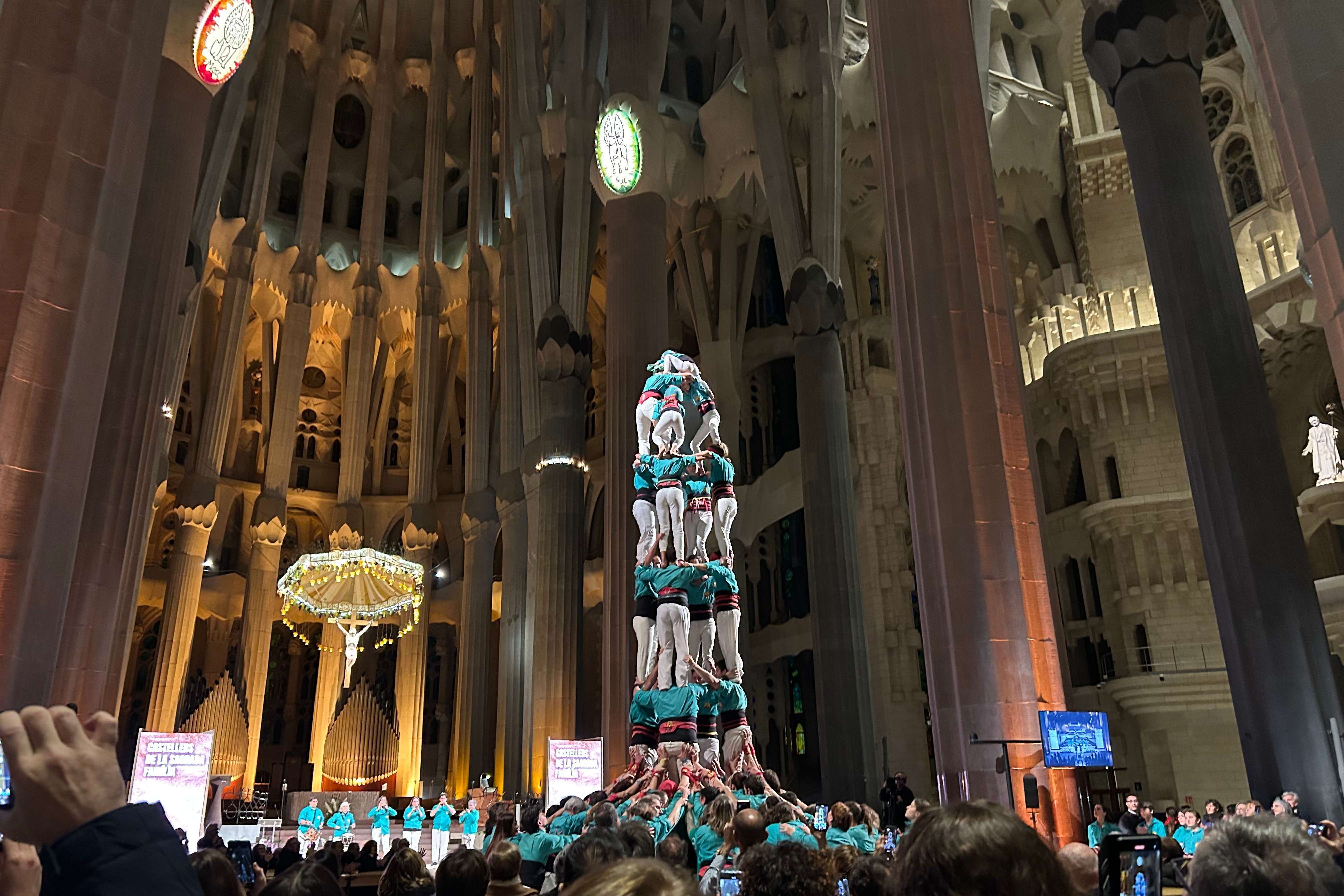 Castellers de la Sagrada Família complete their castell inside the basilica