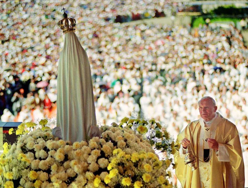 Pope John Paul II celebrates Mass May 12, 1991 in the Chapel of the Apparition in front of the statue of Virgin of Fatima in Fatima where about a million believers attended the Procession of Candles. (Photo by DERRICK CEYRAC/AFP via Getty Images)