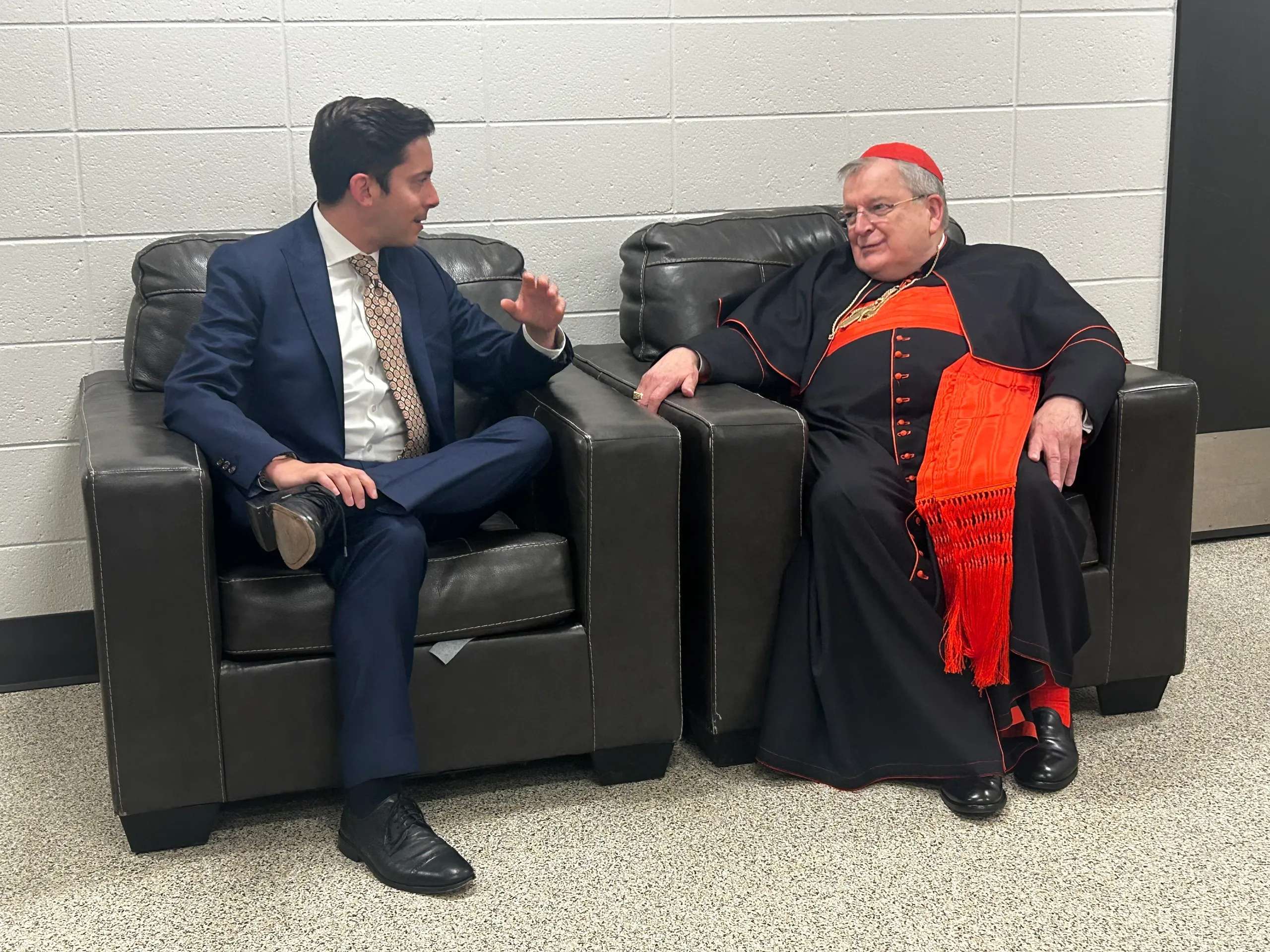After his June 13 Zeale News interview, Michael Knowles greeted Cardinal Raymond Burke, who consecrated the U.S. to the Sacred Heart of Jesus the day prior. (Credit: Zeale News)